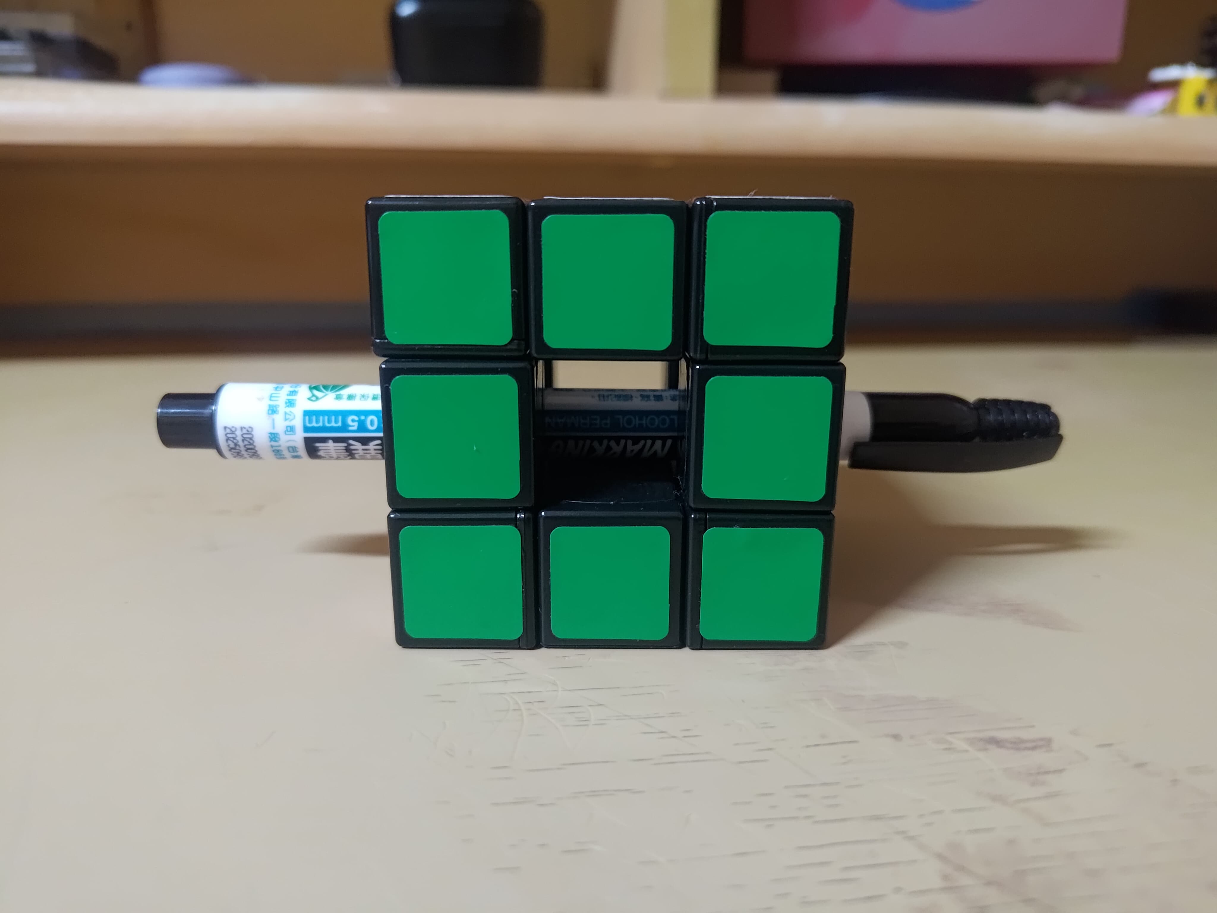 Lanlan void cube with a marker pen through it